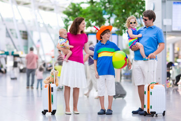 Family with kids at airport