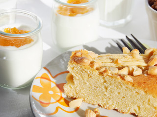 Breakfast with apple pie garnished with almonds and natural yogurt with apricot jam