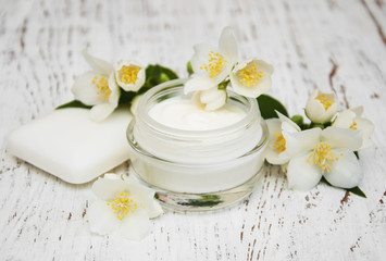 Obraz na płótnie Canvas face and body cream moisturizers with jasmine flowers on white w