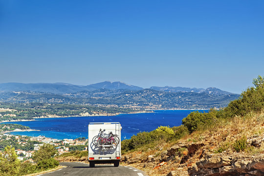 Caravan RV camper van on the road at the mediterranean shore