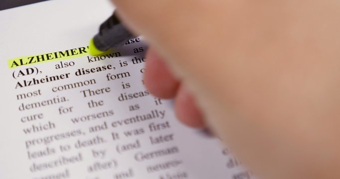 The definition of Alzheimer being emphasized by a yellow marker
