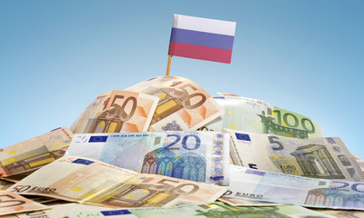 Flag of Russia sticking in a pile of various european banknotes.