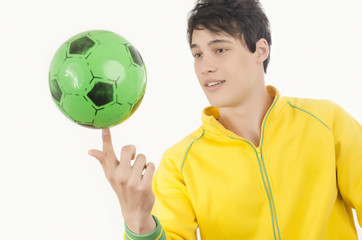 Young man playing with a football ball. Attractive man spinning a ball on his finger. Isolated on white.