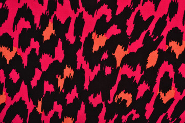 Pink and orange leopard pattern. Colorful spotted animal print as background.