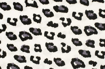Black and grey leopard pattern. Black and white spotted animal print as background.