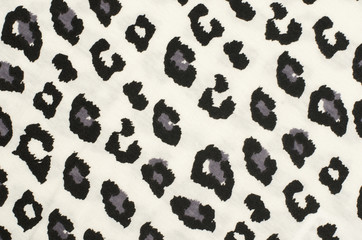 Black and grey leopard pattern. Black and white spotted animal print as background.