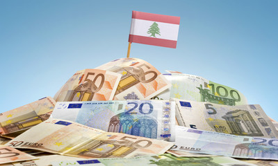 Flag of Lebanon sticking in a pile of various european banknotes