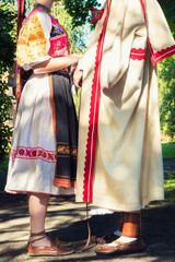 Young anonymous couple in folklore costumes