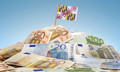Flag of Maryland sticking in a pile of various european banknote