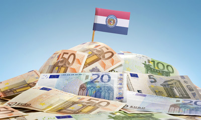 Flag of Missouri sticking in a pile of various european banknote