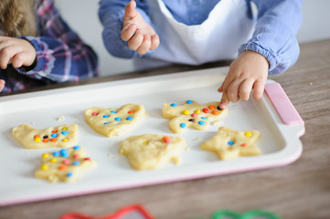 little kids baking funny colourful cookies