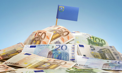 Flag of Nevada sticking in a pile of various european banknotes.