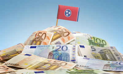 Flag of Tenesse sticking in a pile of various european banknotes