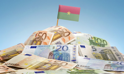 Flag of Burkina Faso sticking in a pile of various european bank