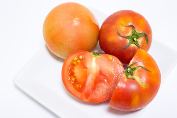 Fresh tomatoes on white background.