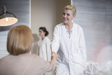 Dentist greeting patient in lobby