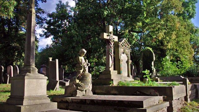 statues, crosses and tumbs in a cemetery