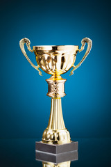 gold cup trophy on blue background