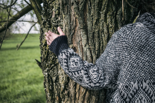 Close-up of woman hugging a tree
