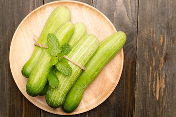 Fresh cucumber on wooden plate,healthy food