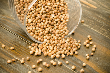 Coriander seed in the glass on wooden background,food seasoning