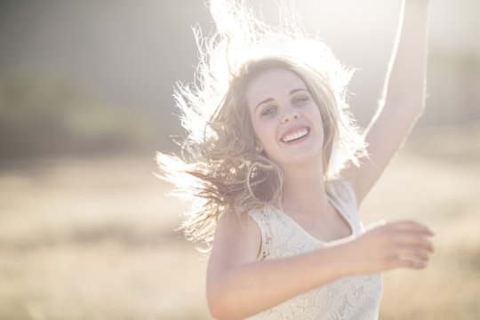 South Africa, Happy young woman dancing in field