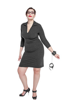 Beautiful plus size woman in black dress with handcuffs isolated