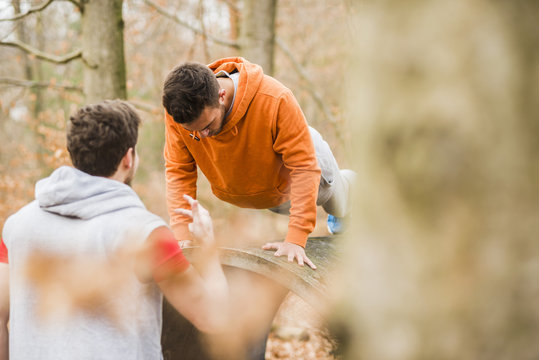 Two young men exercising in forest