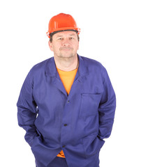 Man working clothes with arms in pockets.