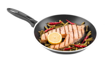 Frying pan with salmon steak.
