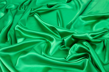 Fototapeta premium Green silk cloth with soft folds.