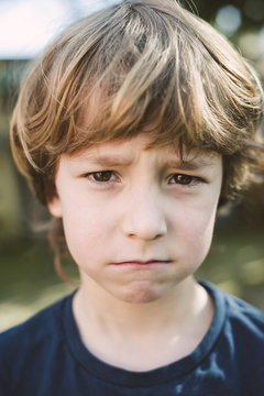 Portrait of little boy pouting mouth