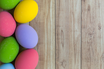 Fototapeta na wymiar Colorful eggs on wood