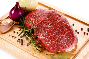 Fresh raw beef on cutting board on white background 