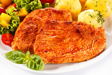 Fried chicken fillets, boiled potatoes and vegetable salad 