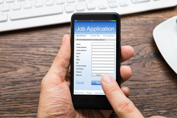 Person Hands Filling Job Application On Mobile Phone