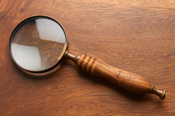 Magnifying Glass On Wooden Background