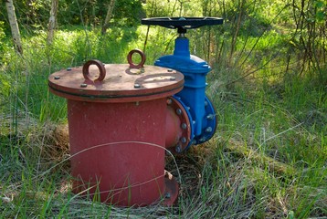 Old expansion pipe of drink water pipes joined with new blue valve and new blue joint members. New dump valve.  Extreme kind of corrosion, metal corroded texture.