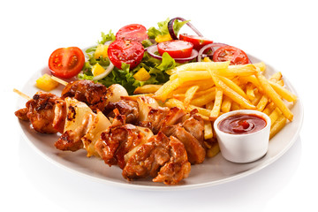 Shashlik - grilled meat, chips and vegetables 