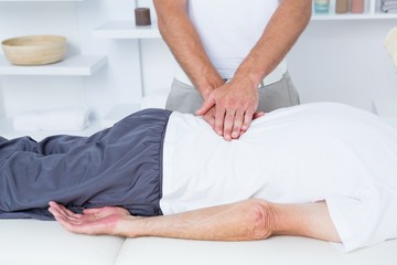 Obraz na płótnie Canvas Physiotherapist doing back massage to his patient