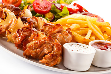 Shashlik - grilled meat, chips and vegetables 