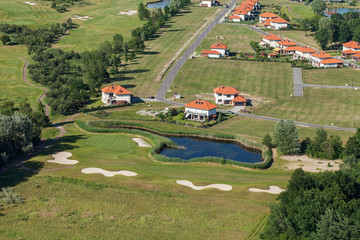 Aerial view over golf field bridge