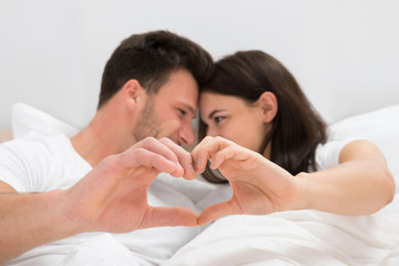 Couple Looking At Each Other Forming Heart Shape