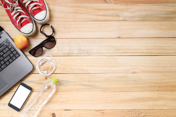 Outfit of traveler, student, teenager, young woman or guy. Overhead of essentials for modern young person. Different objects on wooden background.