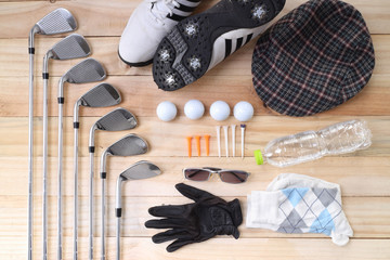 Golf equipment on wood floor preparing for good game
