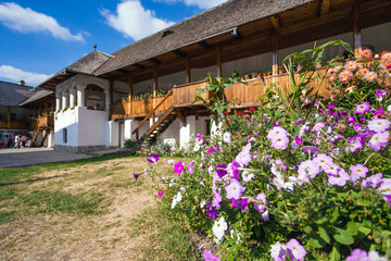 Fototapeta premium Flowers inside the old orthodox Polovragi monastery courtyard