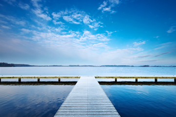 A jetty on a cold winters morning walking along the jetty one must choose left or right?
