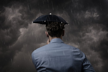 Business man with small umbrella in a heavy storm © Andreas Berheide