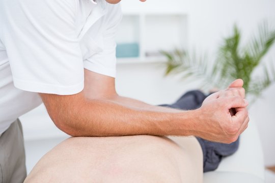 Physiotherapist doing back massage 