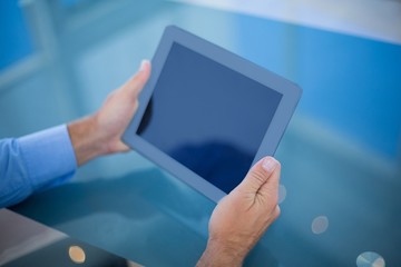 Businessman using his tablet 